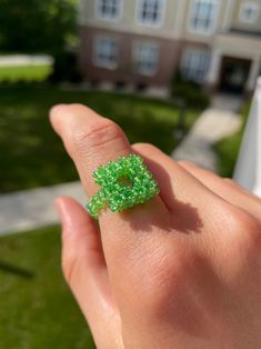 Small square hand beaded ring in a lovely bright iridescent green. Made with glass beads and nylon thread. The band is stretchy so the ring will best fit US ring sizes 6-8. Avoid contact with water to help it last. Handmade Green Rectangular Ring, Green Beaded Rings For Gifts, Green Beaded Rings For Gift, Handmade Square Green Jewelry, Iridescent Green, Beaded Rings, Hand Beading, Rings Statement, Statement Rings