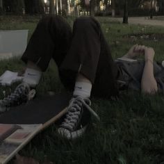 a man laying on the ground with his skateboard