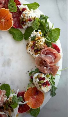 a white plate topped with fruit and veggies on top of a marble counter