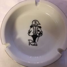 a white bowl with a drawing of a man on it