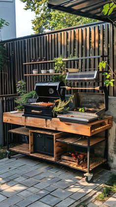 an outdoor bbq with grill and potted plants