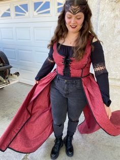 a woman in a red and black costume is posing for the camera with her hands on her hips