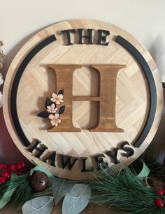 a wooden sign with the letter h on it