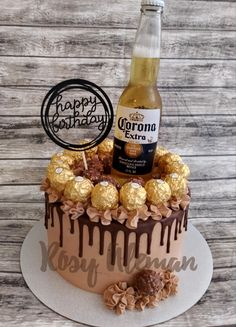 a birthday cake with a bottle of beer and chocolates