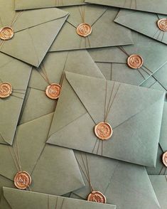 many envelopes with coins on them are stacked up in the shape of an origami