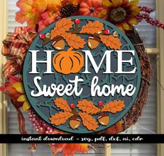 a wreath with the words home sweet home on it and pumpkins, leaves, and acorns