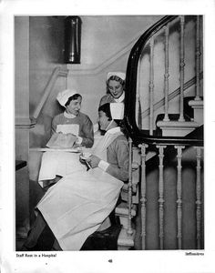 three women in aprons are sitting on the stairs and one woman is reading a book