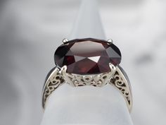 This beautiful white gold mounting has wonderful large prongs that really make this garnet gemstone really stand out! This gem is a gorgeous deep red garnet, in an east to west oval cut. Known for its exceptional color and play of light, this gem is opulent and sophisticated. Metal: 14K White GoldGem: Garnet 9.03 CaratsGem Measurements: 14.7 x 11.8 mm, OvalRing Size: 8.50Marks: "UTC 14K" Stamped on the inside band Classic Burgundy Ruby Ring For Formal Occasions, Elegant Garnet Solitaire Ruby Ring, Elegant Solitaire Garnet Ruby Ring, Elegant Burgundy Ruby Gemstone Ring, Elegant Burgundy Garnet Rings, Elegant Burgundy Ruby Ring, Garnet And Gold, Gold Solitaire Ring, European Cut Diamonds