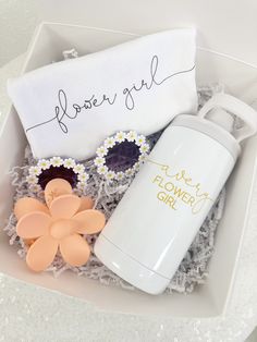 a flower girl gift box with a white water bottle