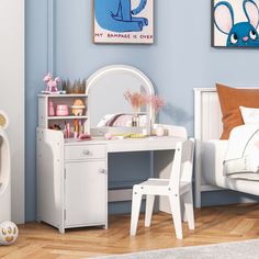 a child's bedroom with blue walls and white furniture, including a bed, desk, mirror and toy chest