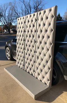 a car is parked next to a wall made out of leather