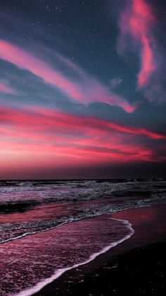 pink and blue sky over the ocean at night