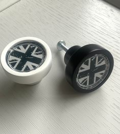 two black and white knobs sitting on top of a table