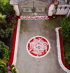 an overhead view of a red and white rug on the ground in front of a building