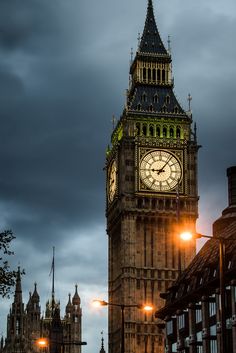 the big ben clock tower towering over the city of london, england at night time