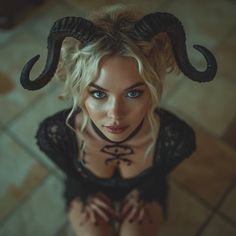 a woman with horns on her head posing for the camera