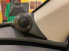 a close up of a speaker on the back of a car's headrest