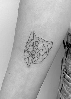 a black and white photo of a woman's arm with a geometric tattoo on it