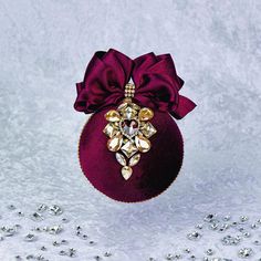 a red ornament with a bow on it