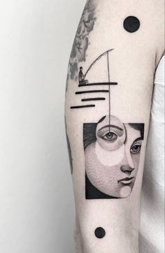 a woman's arm with a black and white tattoo on it