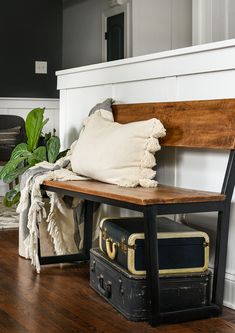 a wooden bench sitting on top of a hard wood floor