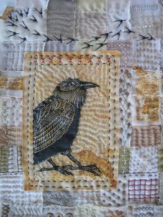 a patchwork quilt with a bird on it