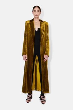 Part of the Galvan x Martha Hunt capsule, this long coat makes a statement in soft, silky velvet. The plunging neckline with narrow lapels is elegant and feminine, while the loose body has a relaxed, effortless feel. Throw over the matching Liquid Velvet Trousers for a head-to-toe look. This style is part of the Galvan Mustard Kimono Outfit, Luxury Velvet Outerwear For Fall, Velvet Notch Lapel Evening Outerwear, Evening Velvet Outerwear With Notch Lapel, Velvet Notch Lapel Outerwear For Evening, Evening Velvet Outerwear With Lapel Collar, Chic Velvet Evening Outerwear, Velvet Single-breasted Outerwear For Evening, Long Velvet Coat For Fall