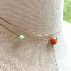 Stylish and simple.Features a red aventurine gemstone, a small mint green glass bead, nylon cord.The necklace is 14” with a 2” extension.The necklace will be gift boxed. Delicate Adjustable Everyday Choker, Adjustable Dainty Choker For Layering, Adjustable Natural Stone Necklaces For Summer, Adjustable Double Strand Dainty Necklace, Minimalist Adjustable Choker For Summer, Adjustable Minimalist Choker For Summer, Dainty Green Adjustable Choker, Dainty Adjustable Double Strand Necklace, Dainty Double Strand Adjustable Necklace