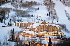 a ski resort lit up at night in the mountains