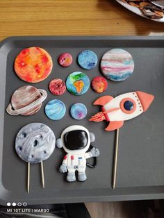 a tray that has some food on it and an astronaut toy in the middle of it