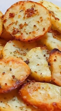 some potatoes are sitting on a plate with seasoning sprinkled on them and ready to be eaten