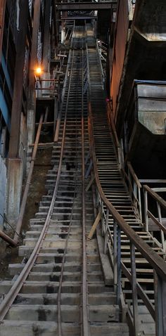 an abandoned train track in the middle of a city with no people or vehicles on it