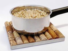 a metal bowl filled with rice sitting on top of wine corks