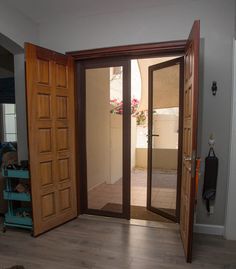 an open door leading into a room with hard wood floors