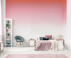 a bedroom with pink and white walls, furniture and rugs on the floor in front of a bed