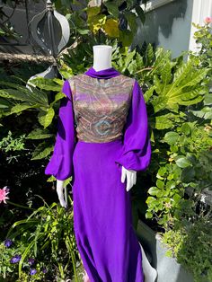 "Vintage 1970s Rich Purple Maxi Dress Beautiful Vintage Piece Floor Length  Glittery Paisley Panel on Bodice Made of Glittery Thread Jobi Brand  Bat Wing Sleeves with Elasticated Cuffs Zip Fastening Made of Polyester Measurements Marked Size 42 Bust - 38\" Waist - 30\" Hips - 42\" Length - 55\" Sleeve - 25\"" Vintage Evening Dresses For Festive Season, Vintage Festive Evening Dress For Party, Festive Vintage Evening Dress For Party, Vintage Long Sleeve Dress For Party, Fitted Vintage Maxi Dress For Party, 1970s Style Floor-length Dress For Party, 1970s Style Floor-length Party Dress, Vintage Long Sleeve Evening Dress, Vintage Purple Party Dress