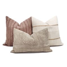 three decorative pillows on white background with brown and tan accents, one in the shape of a diamond