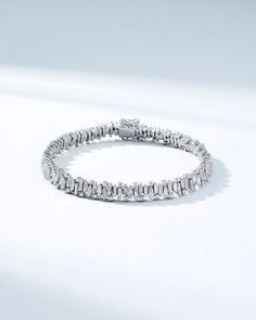 Handcrafted in 18-karat gold, this bracelet features an artfully organized array of vertically stacked baguette diamonds, alternating with round white diamonds, creating in a stunning statement piece. Set with 6.51 carats of white diamonds, this bracelet is crafted to capture light and attention, ensuring it sparkles brilliantly on your wrist. Details 18k yellow gold, rose gold or white gold 6.51 carats of baguette and round white diamonds Bracelet measures 7" inches in length Box clasp with saf Luxury Platinum Diamond Bracelet With Baguette Diamonds, Timeless Tennis Bracelet With Baguette Diamonds, Diamond White Platinum Bracelet With Baguette Diamonds, Platinum Diamond Bracelet With Baguette Diamonds In Diamond White, Modern Tennis Bracelet With Baguette Diamonds And Cubic Zirconia, Timeless White Gold Diamond Bracelet With Baguette Diamonds, Luxury Diamond Tennis Bracelet With Baguette Cut, Luxury Diamond Tennis Bracelet Baguette Cut, Luxury Round Tennis Bracelet With Baguette Diamonds