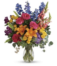 a vase filled with lots of colorful flowers