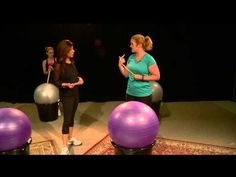 two women are talking to each other in front of exercise balls