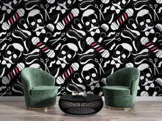 two green chairs sitting next to each other in front of a black and white wall