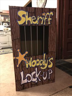 a cardboard box with the words sheriff woody's lock - up painted on it