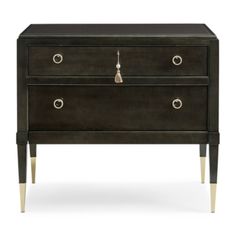 a black dresser with two drawers and brass legs