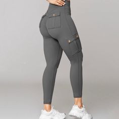 Experience the perfect combination of fashion, comfort, and functionality with our Comfy Curve Enhancing Cargo Leggings. Expertly crafted to complement your body, these leggings accentuate your curves in all the right places, providing a comfortable and fashionable appearance. Ideal for any occasion, whether it's a casual outing or a workout, the trendy cargo pockets add both style and practicality. With their incredibly soft fabric, these leggings offer ultimate comfort without compromising on Non-stretch Mid-rise Leggings With Pockets, Versatile Stretch Leggings With Pockets, Mid-rise Tight Leggings With Pockets, Versatile High Stretch Leggings With Pockets, Fitted Mid-rise Gray Leggings, Versatile High-stretch Leggings With Pockets, Gray Fitted Mid-rise Leggings, Pilates Leggings With Pockets, High Stretch Leggings With Pockets For Pilates