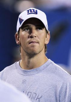 a close up of a tennis player wearing a hat and looking off to the side