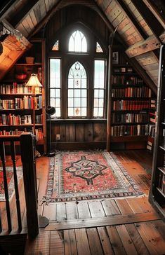 a room filled with lots of books on top of a wooden floor next to a window