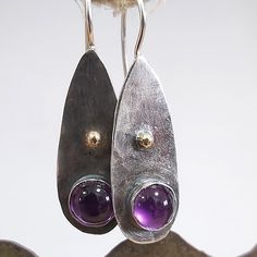 Purple Stone Earrings, Sterling Gold Amethyst, Sterling Silver Dangle, Violet Earrings, Natural Stone Earrings, Sterling Purple Jewelry These pretty Silver amethyst earrings are hammered from Sterling silver, Amethyst bezel set cabochons and Two small 14kt gold balls. There are hooks behind the earrings to catch the Sterling ear-wires. Elegant everyday earrings. Completely handmade. Measurements: -------------------- ★   LENGTH -  1.5 inches from end of the ear-wires ★   WIDTH -  0.5 inches ---- Unique Amethyst Teardrop Earrings, Purple Amethyst Earrings, Violet Earrings, Bezel Set Earrings, Unique Handmade Earrings, Natural Stone Earrings, Earrings Handmade Dangle, Hammered Earrings, Purple Jewelry