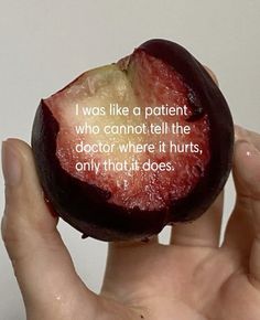 a person holding an apple in their hand with a quote written on the inside of it