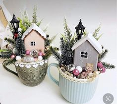 two mugs with small houses in them