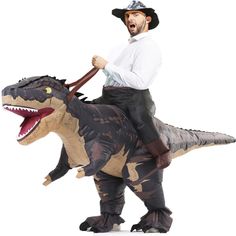 a man riding on the back of an inflatable dinosaur